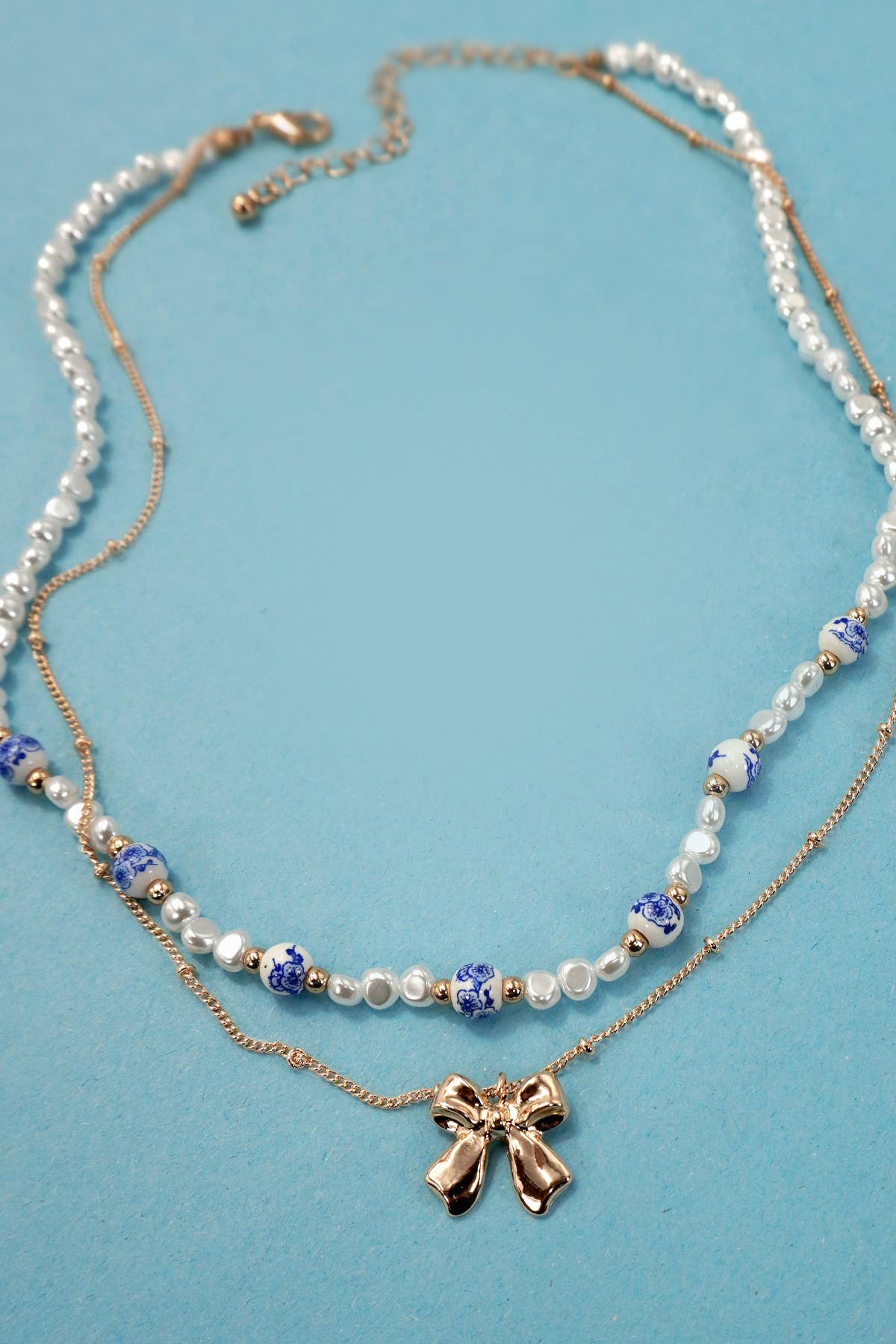 JOSSLYN by wall to wall - CERAMIC PORCELAIN PEARL BOW LAYER NECKLACE | 80N91555