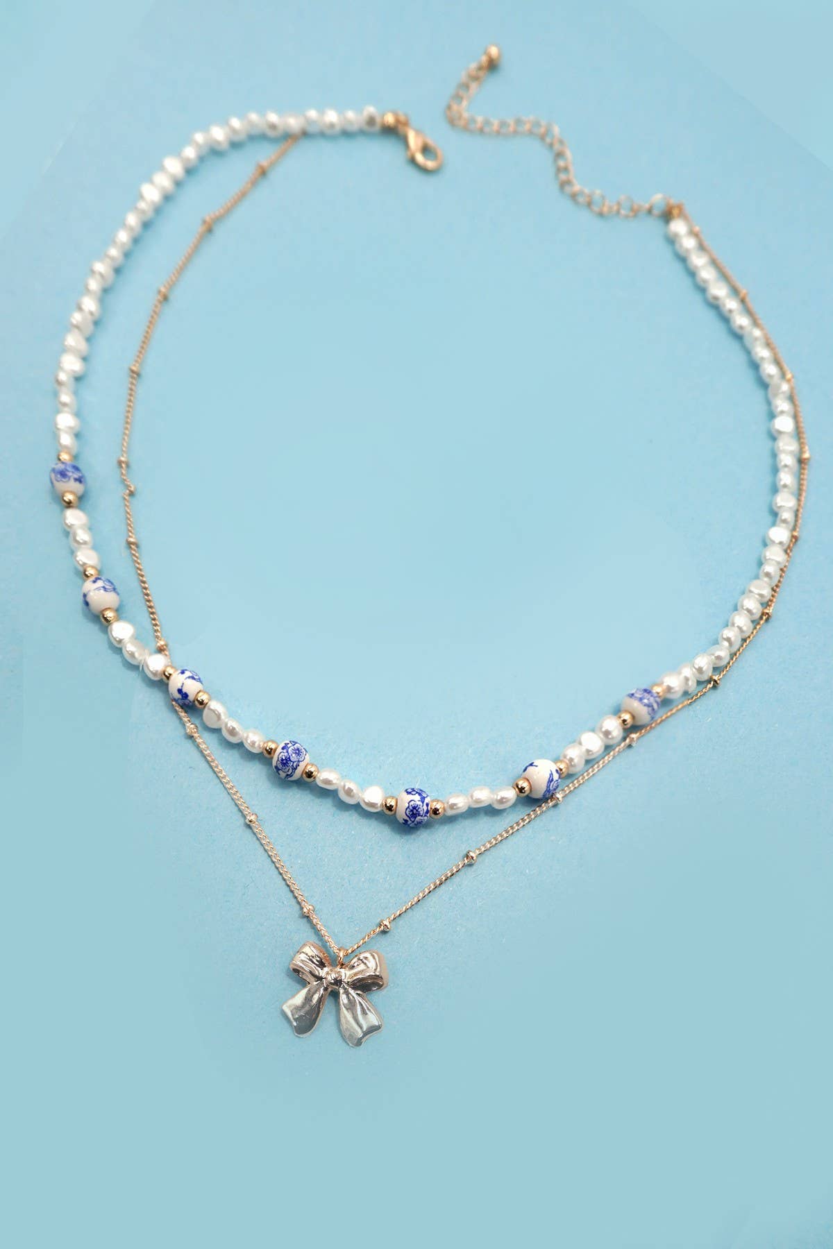JOSSLYN by wall to wall - CERAMIC PORCELAIN PEARL BOW LAYER NECKLACE | 80N91555